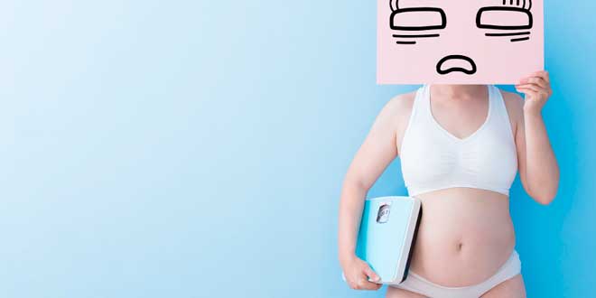 Woman holding a scale