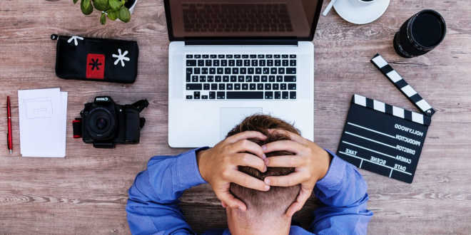 Stressed man working on his computer Stressed man working on his computer