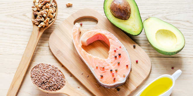 Salmon, walnuts, avocado, seed and oil on a table Salmon, walnuts, avocado, seed and oil on a table