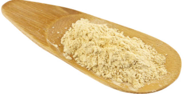 Yellow Maca powder on a wooden spoon Yellow Maca powder on a wooden spoon