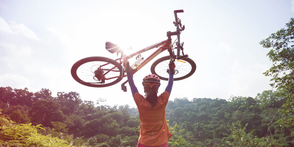 Girl holding a bike