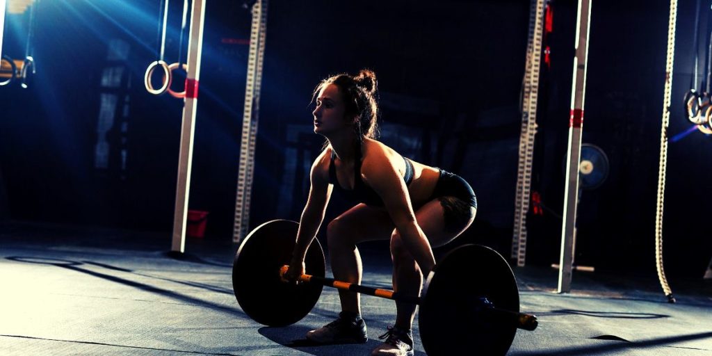 Woman doing a dead lift Woman doing a dead lift