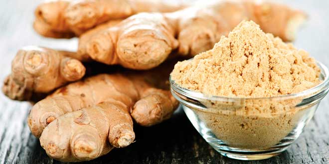 Ginger root and powder in a crystal bowl Ginger root and powder in a crystal bowl