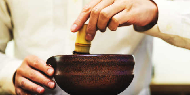 Whisking matcha tea Whisking matcha tea