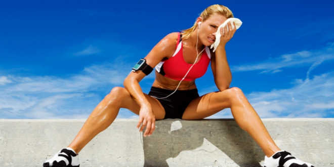 Adult woman sitting on a ledge