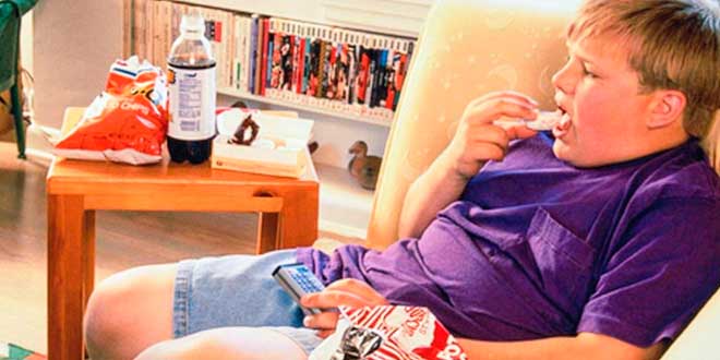 Obese child eating chips