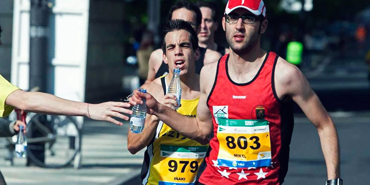 Marathon runners drinking mineral water