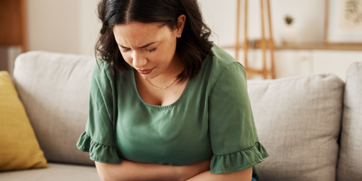 Woman with stomach pain and abdominal bloating Woman with stomach pain and abdominal bloating