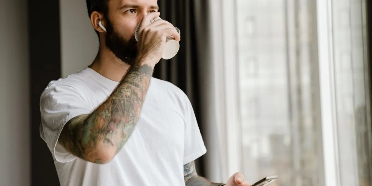 Man drinking coffee before training