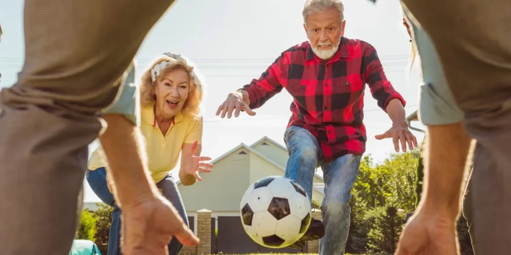 Older adults playing with a soccer ball Older adults playing with a soccer ball