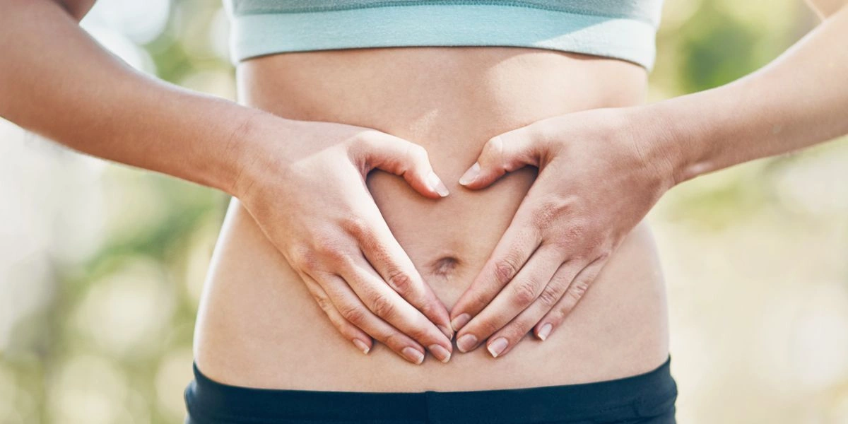 Woman touching her belly relieved from stomach pain