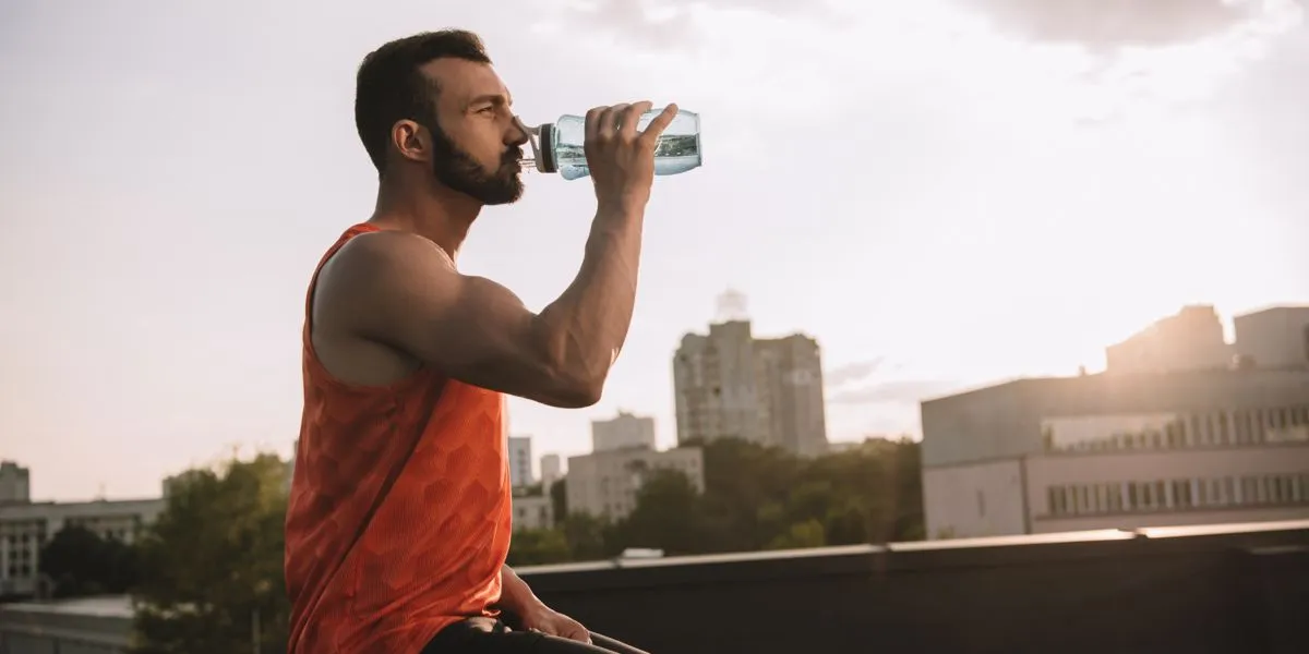 Man drinking water and exercising Man drinking water and exercising