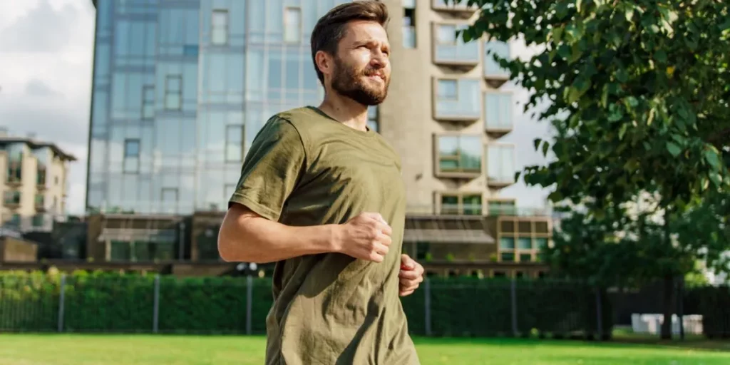 Man with beard running through the city as part of his daily routine to maintain energy Man with beard running through the city as part of his daily routine to maintain energy