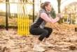 Why do the knees tend to cave inward during squats?
