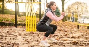 Why do the knees tend to cave inward during squats?